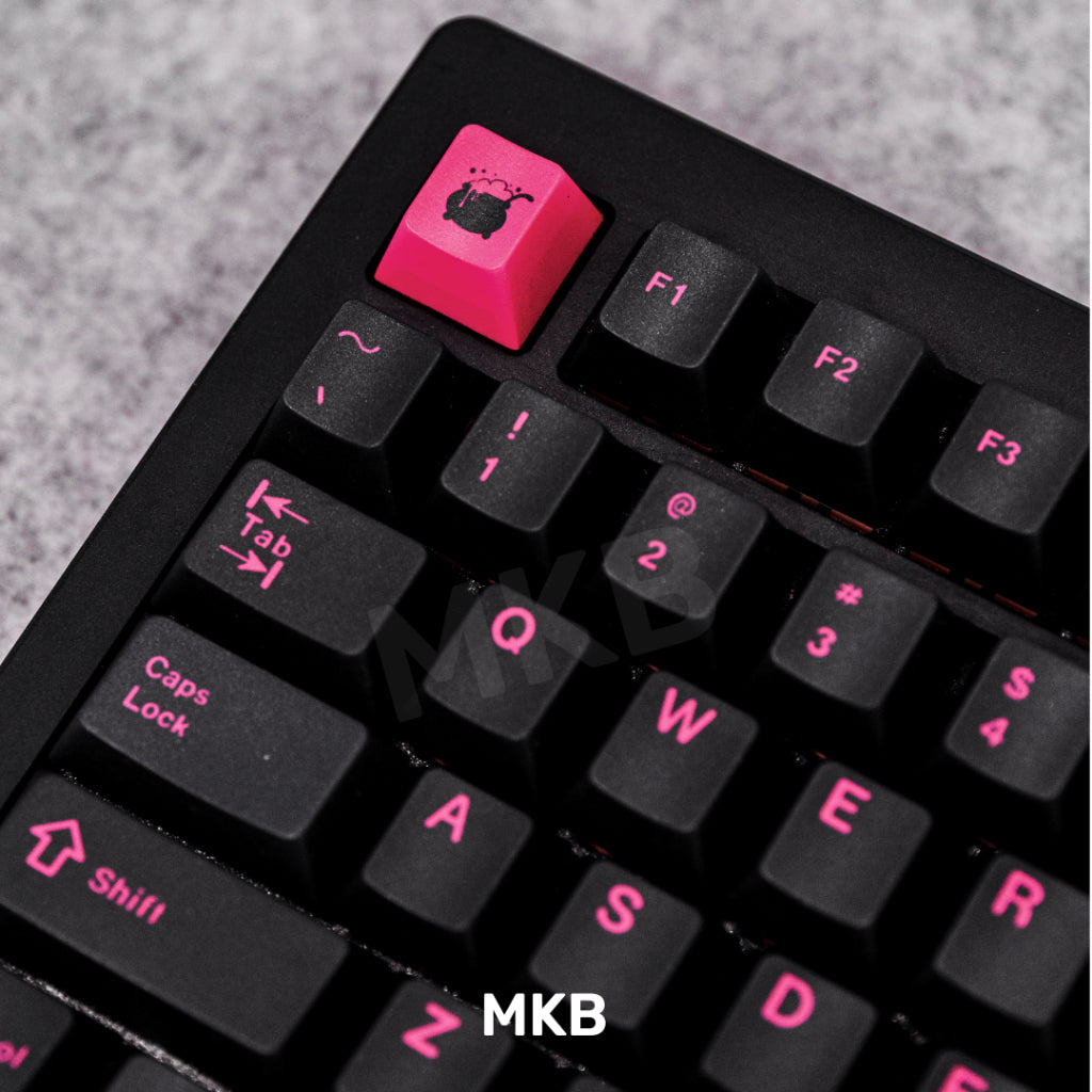 Black and pink keycaps on keyboard, cooking pot icon on the Esc key