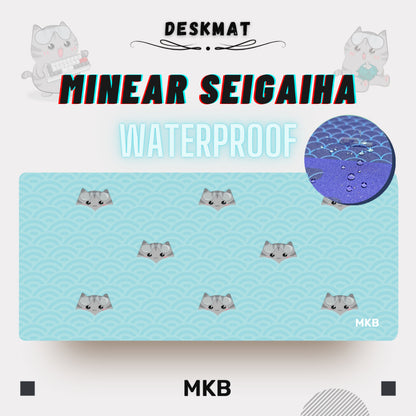 MKB Minear Seigaiha deskmat in Arctic color, combining a soft wave pattern with a whimsical cat design.